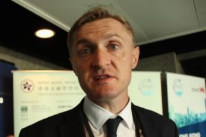 Man in formal attire speaking indoors.