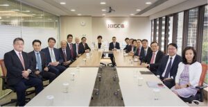 Business professionals seated around a conference table in a formal meeting.