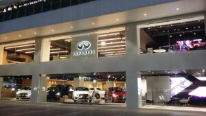 Exterior view of an Infiniti car showroom at night.