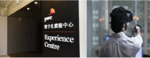 Signboard for PwC Experience Centre with part of a person in the background.