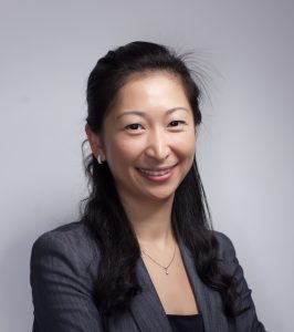 Professional woman smiling confidently in business attire.