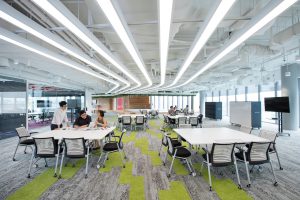 Modern office space with open seating and bright lighting.
