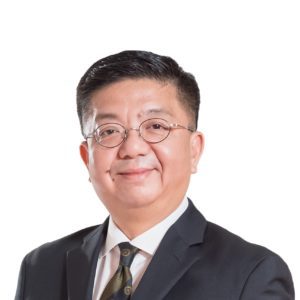 Professional man in a suit and tie smiling gently.
