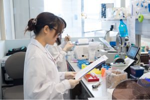 Scientists working diligently in a laboratory setting with research equipment.