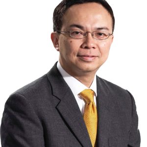 Professional man in suit with glasses and yellow tie.