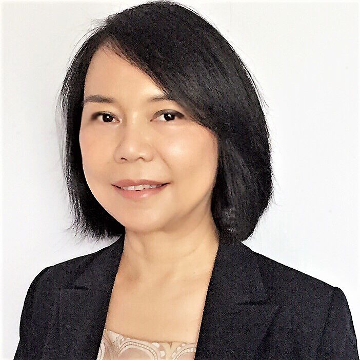 Professional portrait of a woman with short black hair in business attire.