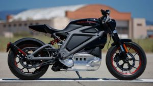 Sleek black electric motorcycle parked outdoors on a sunny day.