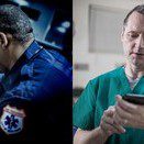 Two medical professionals, one in emergency uniform, the other in scrubs, using devices.