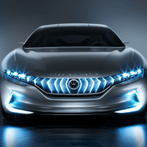 Futuristic silver car with glowing blue grille and headlights on a dark background.