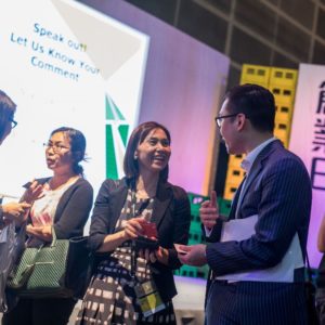 People networking and exchanging business cards at a professional event.