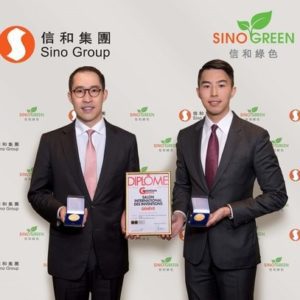 Two men in suits holding awards at a Sino Group event.
