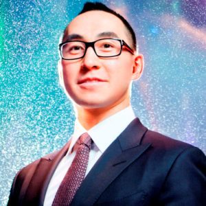 Professional man in glasses and suit against a sparkling background.