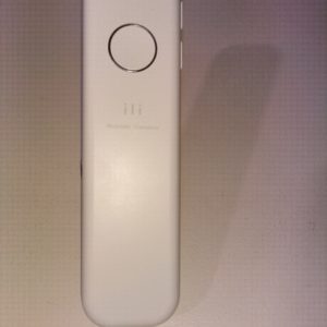 A minimalist white remote control with a circular button and three small indicator lights.