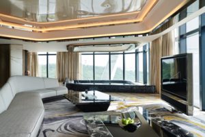 Luxurious modern living room with panoramic windows and elegant decor.