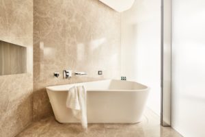 Modern bathroom with a freestanding bathtub and soft lighting.