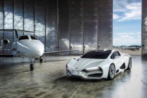 A sleek white sports car parked beside a private jet in a hangar.