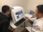 Two men examining medical images on a computer screen in a clinical setting.
