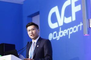 A man speaking at a podium with a blue Cyberport backdrop.