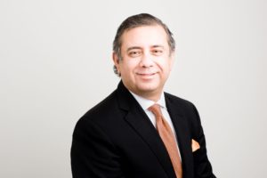 Professional man in suit and tie smiling confidently.