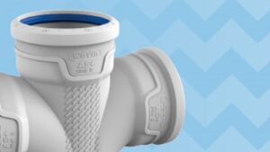 Close-up of a white PVC pipe fitting against a blue zigzag background.