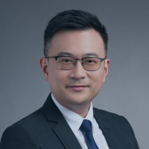 Professional portrait of a man in a suit and glasses.