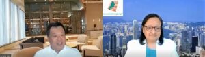 Modern office lounge with city skyline view through large windows.
