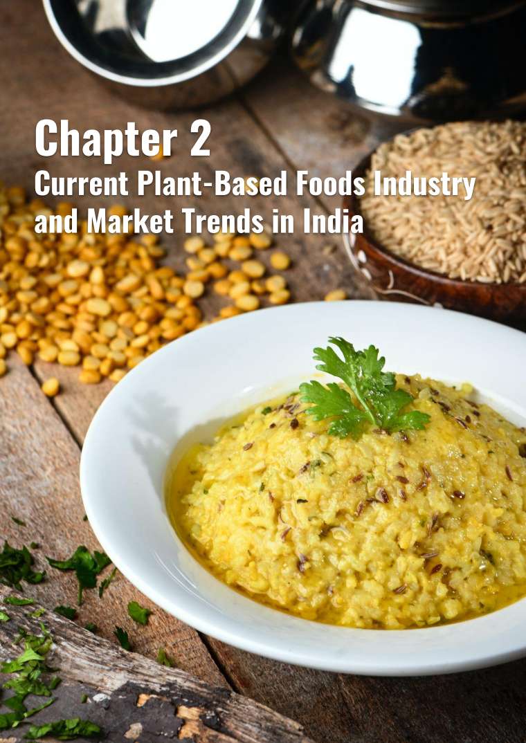 A bowl of lentil dish surrounded by lentils and grains, highlighting plant-based foods in India.