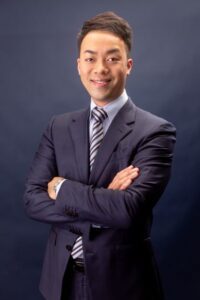 Confident businessman in a suit with arms crossed.