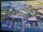 Aerial view of a large harbor with docks and industrial buildings.