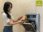 Woman using an Envac waste disposal system to discard waste.