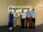 Five professionals stand in front of a durapower sign, two holding certificates.