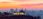 Sunset view of Griffith Observatory with Los Angeles skyline in the background.