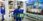 Robot in blue uniform holding a green crate at a tech exhibition with onlookers.