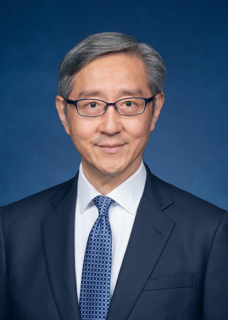 Man in suit with glasses and tie