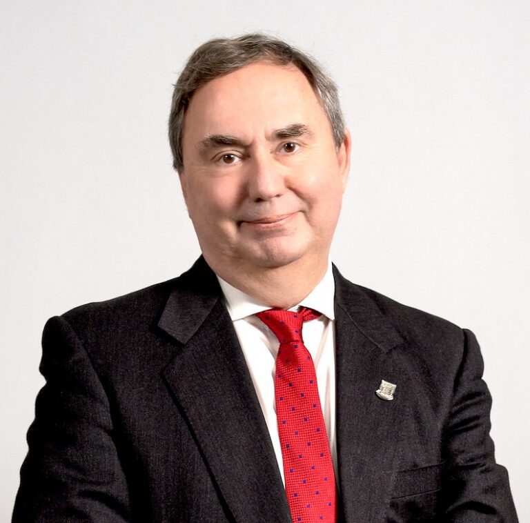 Smiling man in suit with red tie